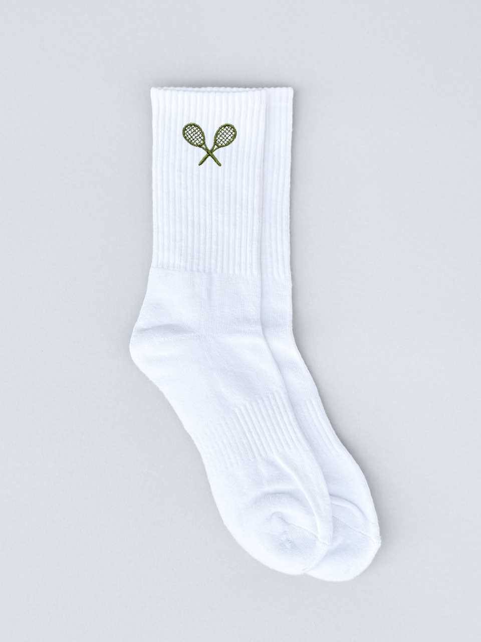 Weiße Socken mit grüner Tennisschläger-Stickerei, flach ausgebreitet